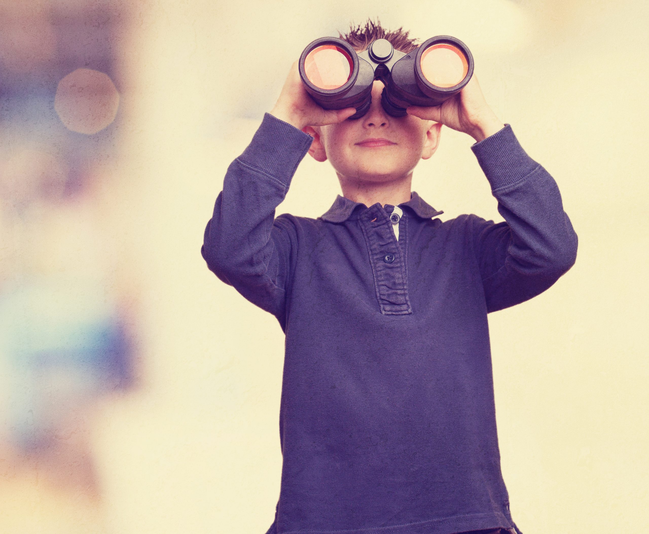 little kid using binoculars